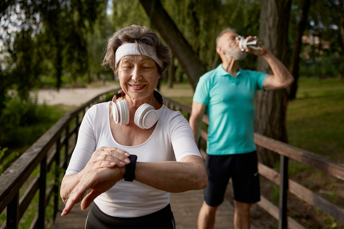 senior-fitness-woman-proud-overtaking-her-tired-husband-morning-running-workout-retiree-cardio-wellness-marathon-jog